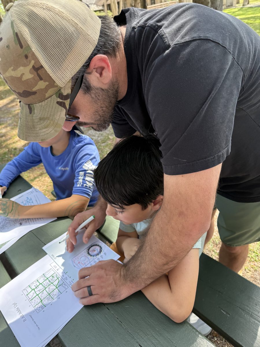 Homeschool students at a Seasons Schoolhouse compass and map activity in Flagler County, FL